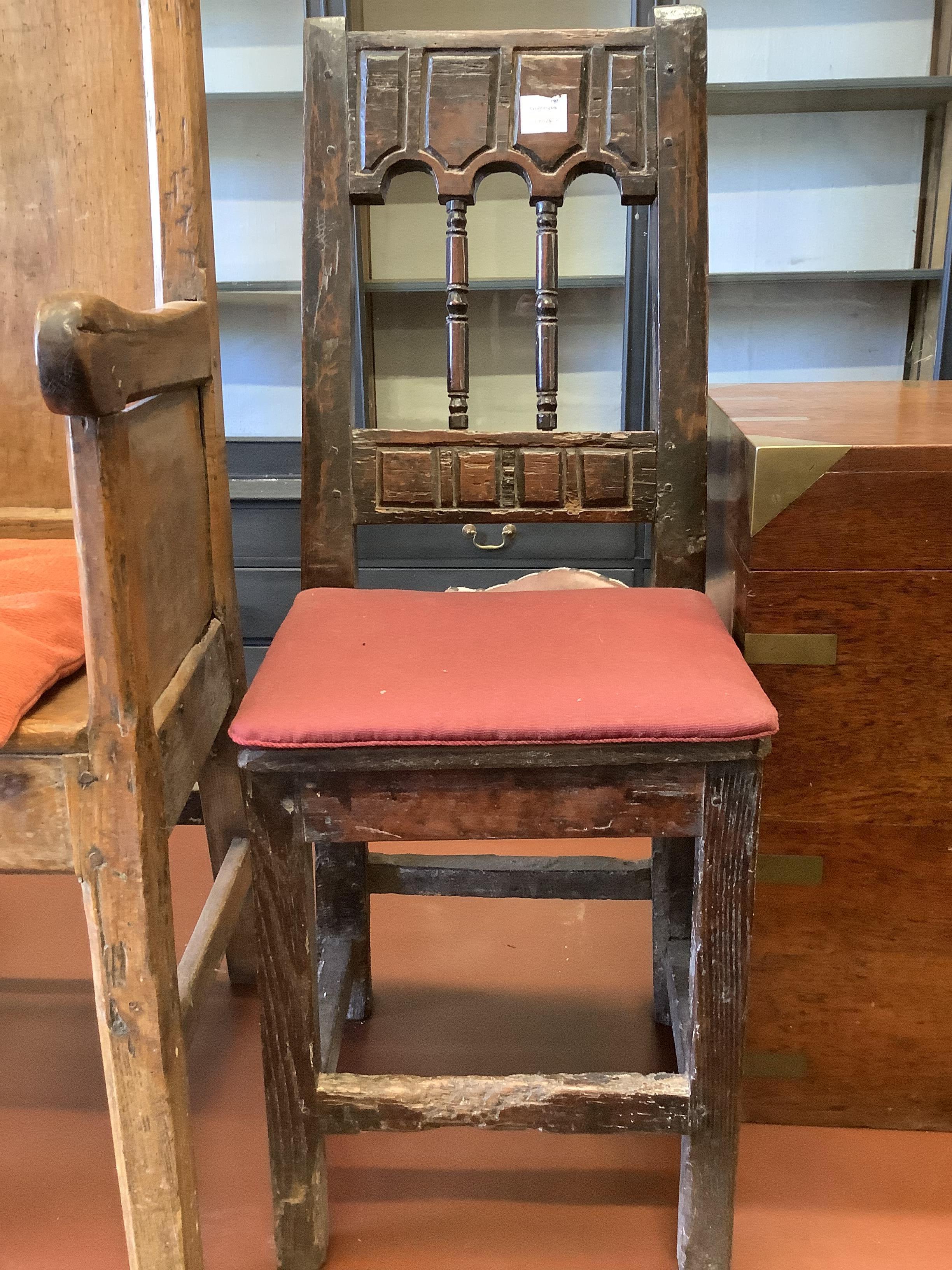 An 18th century stripped pine armchair and a dining chair